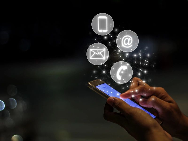 Person using cell phone to email,  call, text or tweet.