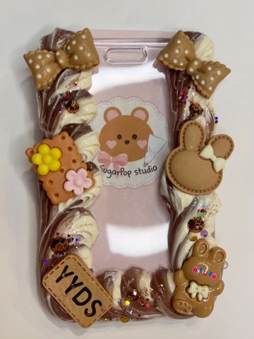 Decorative phone case with cute animal-themed clay charms and bows.