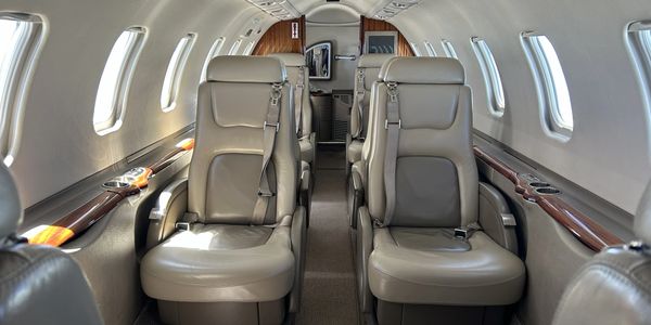 Luxurious seats inside a private jet cabin.