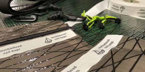 Close-up of sail bag materials and accessories labeled 'marblehead sail bags'.