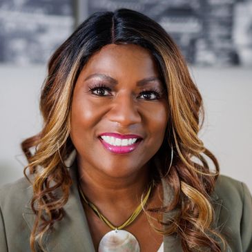 Smiling woman with styled hair and bright lipstick.