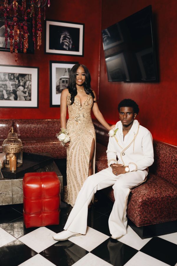 Young couple dressed elegantly for a formal event in a stylish lounge.