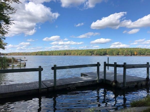 A dock on Paupackan Lake on a summer day