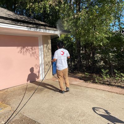 Person power washing a driveway.
