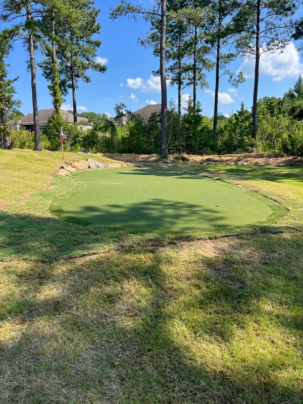 The green holes and flags placed in the turf. 