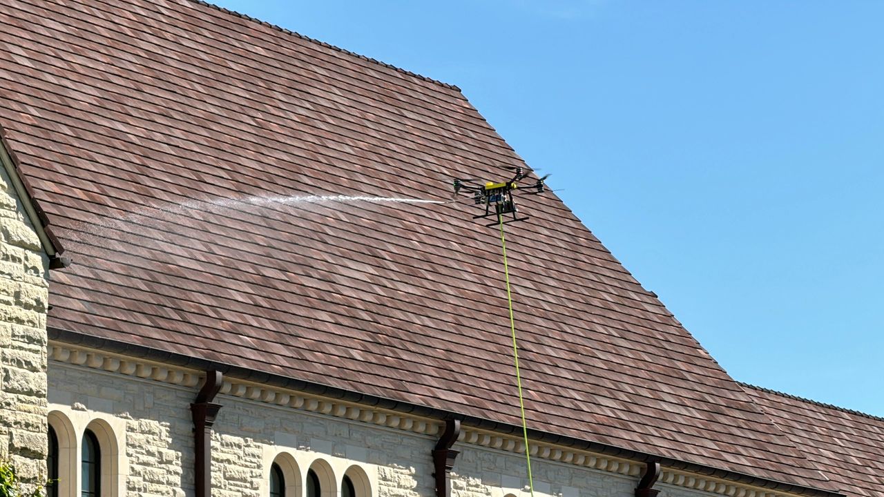 a drone cleaning the roof, providing roof cleaning services with drone-powered solution 