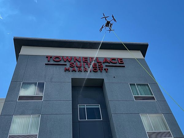 The Marriott hotel's exterior windows and facade are cleaned by Flywash drone operators.