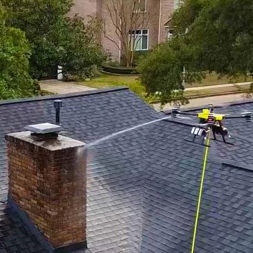 a drone cleaning a roof top which soft wash and cleaning methods.