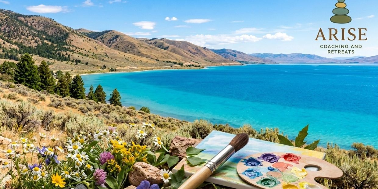 Scenic lakeside view with painting supplies and wildflowers in foreground.