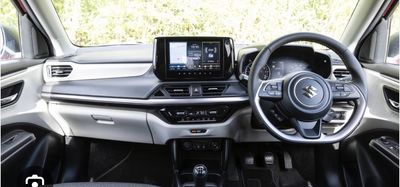 Modern car interior with touchscreen and multifunction steering wheel.