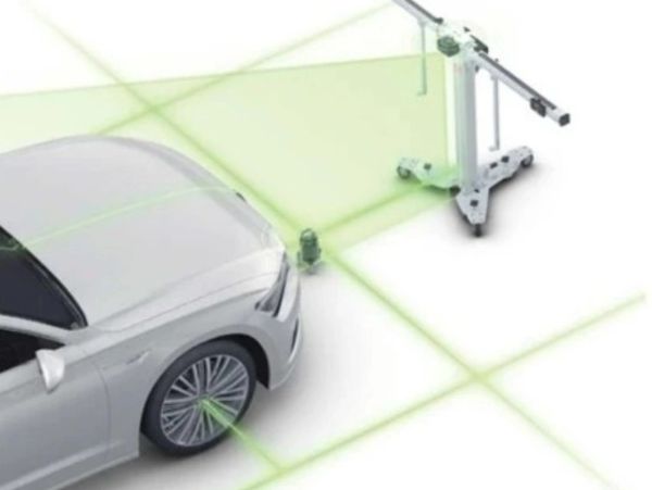 A car aligning its wheels using laser guides for precision.