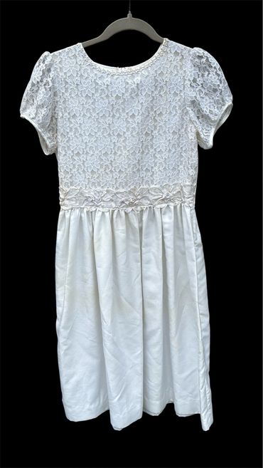White dress with floral lace top and puff sleeves.