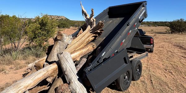 Heavy-duty dump trailer in Lubbock capable of hauling dirt, gravel, brush, and construction debris.