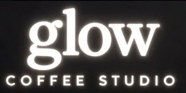Signboard reading 'glow COFFEE STUDIO'.