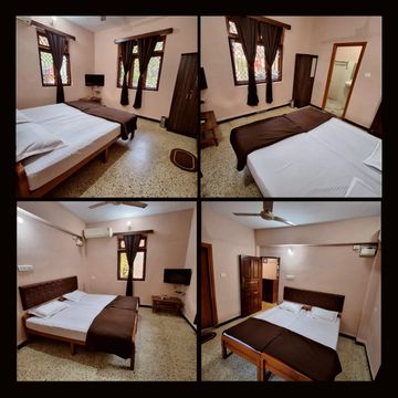 Cozy bedroom with double bed, wooden furniture, and natural light from windows.