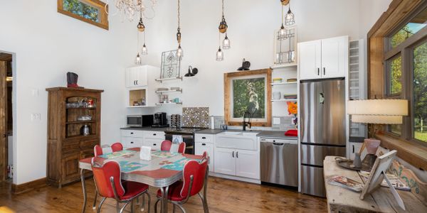 Custom farmhouse style kitchen in home designed by Texas Hill Country Custom Homes builder.