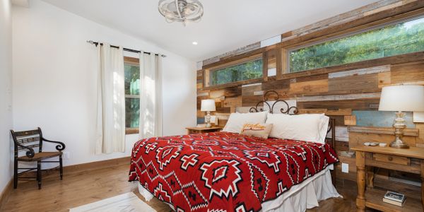 Custom farmhouse style bedroom in home designed by Texas Hill Country Custom Homes builder.