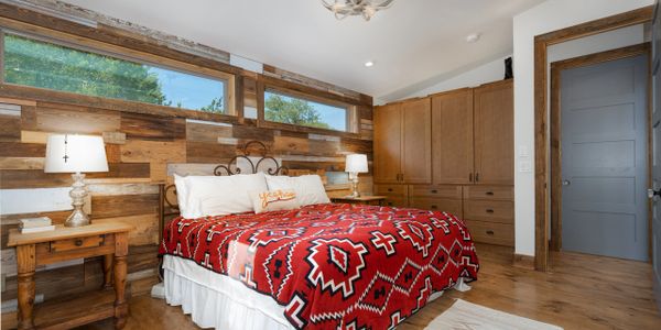 Custom farmhouse style bedroom in home designed by Texas Hill Country Custom Homes builder.