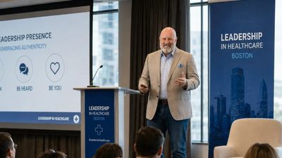 Speaker presenting on leadership in healthcare at a conference.
