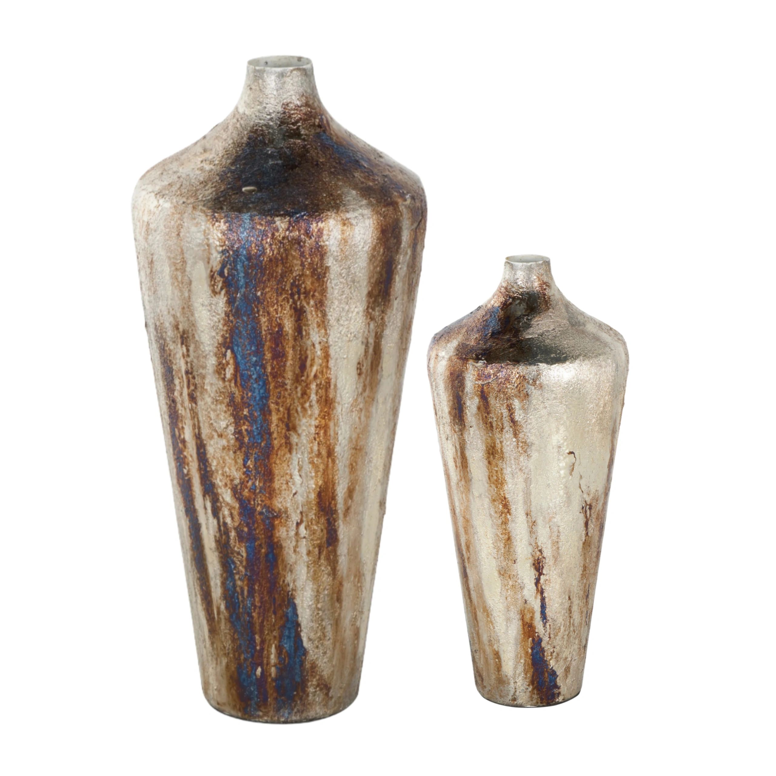 Two rustic ceramic vases with blue and brown glaze accents.