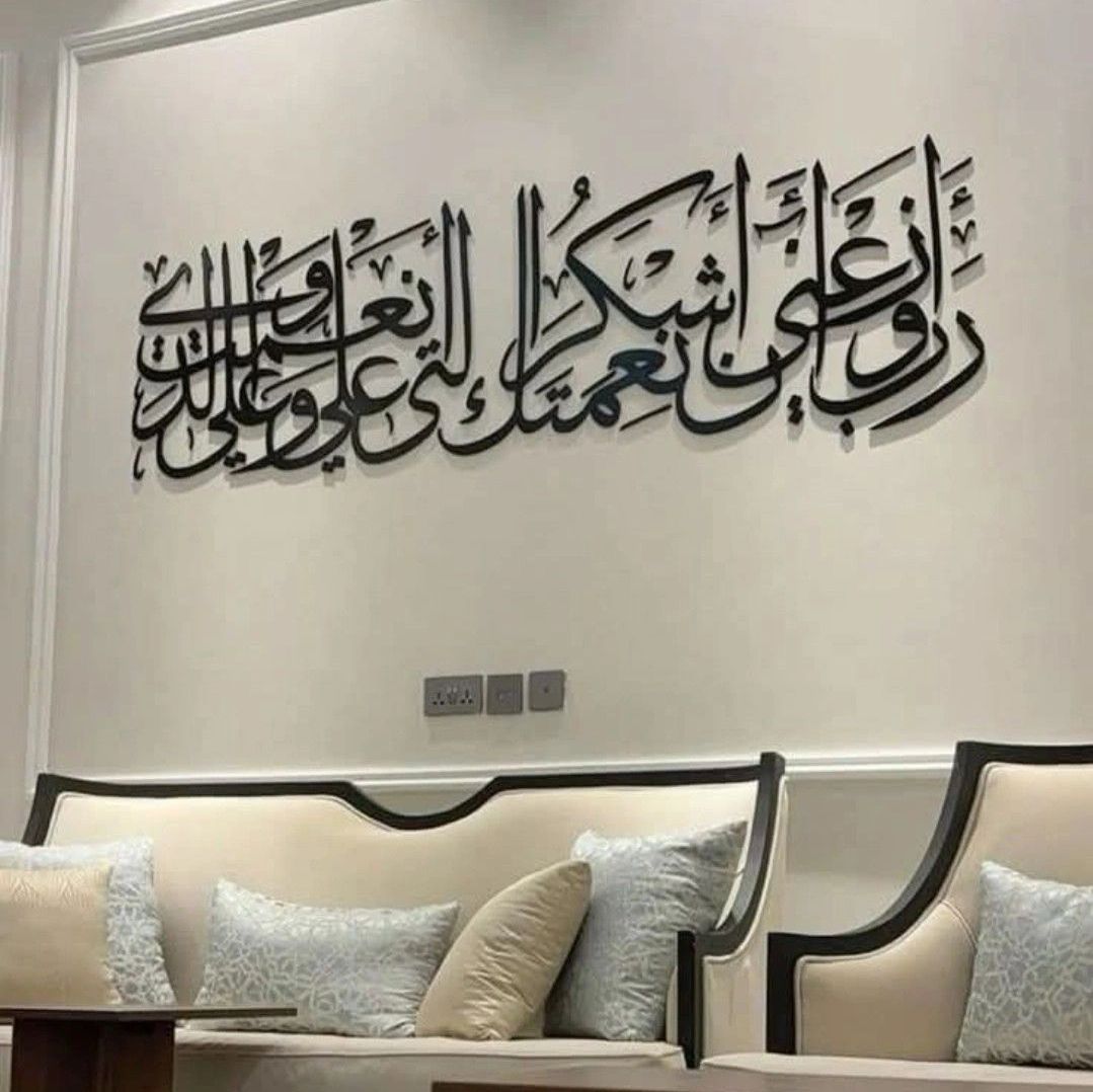 Elegant Arabic calligraphy wall art above a modern beige sofa with cushions.