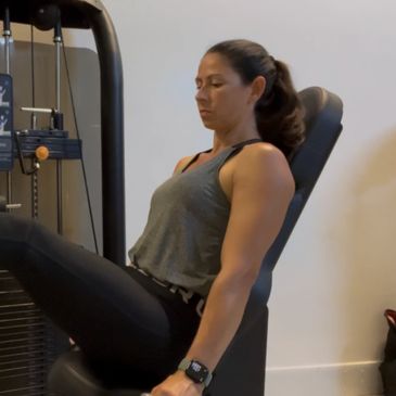 Woman working out on a leg press machine.
