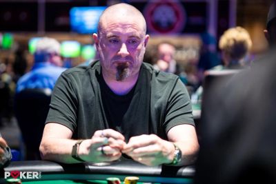 A man playing poker in a casino.