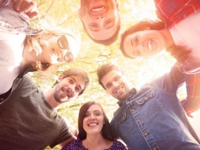 group of smiling people in a circle