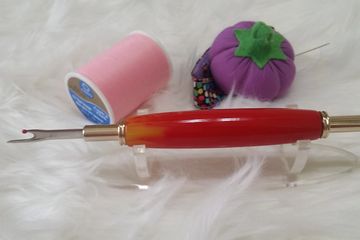 Seam Ripper that is red and orange 