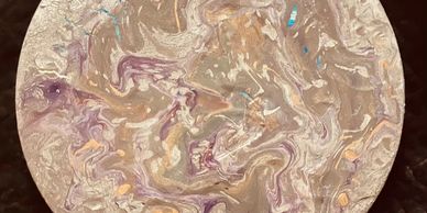 Circular artwork with swirling pastel colors and marbled patterns.