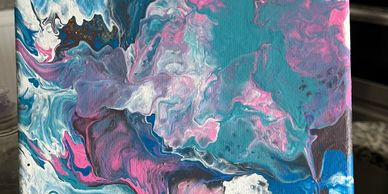 Abstract fluid art with swirling blue, pink, purple, and white colors.