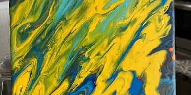 Abstract painting with swirling yellow, blue, and green colors.