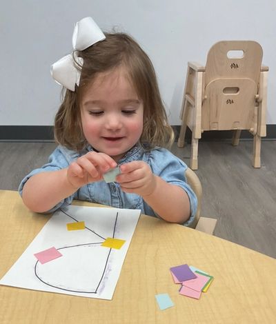 Girl playing with cards on the table