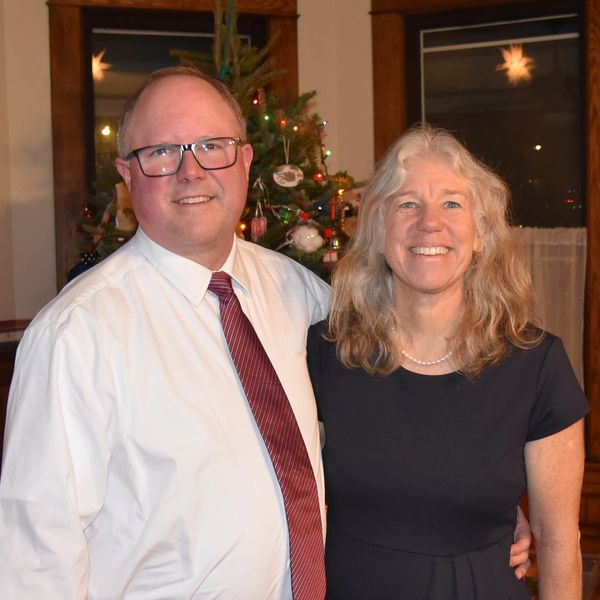 Smiling man and woman (Jeff and Karen) standing in front of a Christmas tree.  online bradley method