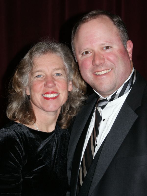 Woman and man smiling wearing formal clothes
