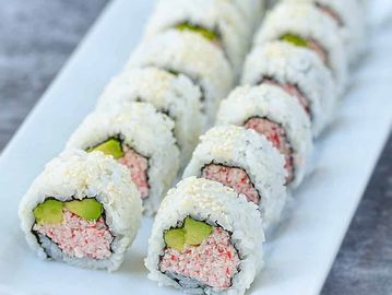 Plate of sushi rolls with crab and cucumber.