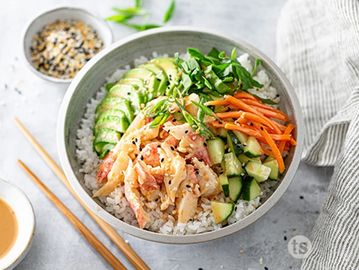 Fresh poke bowl with shrimp, vegetables, and rice.