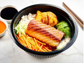 Bowl of rice with grilled salmon and vegetables.
