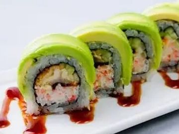 Sushi rolls topped with avocado and sauce.