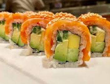 Close-up of sushi rolls with avocado and salmon.