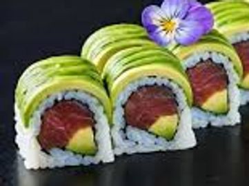 Sushi rolls topped with avocado and edible flowers.