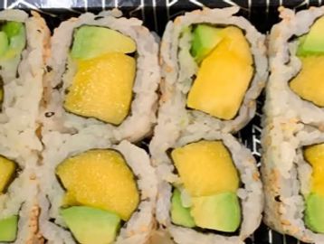 Close-up of sushi rolls with mango and avocado.