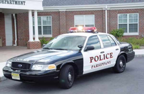A Parsippany police car parked outside a brick building.