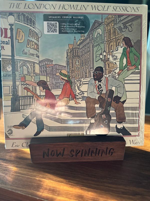 Vinyl album cover of The London Howlin' Wolf Sessions with illustrated musicians on city steps.