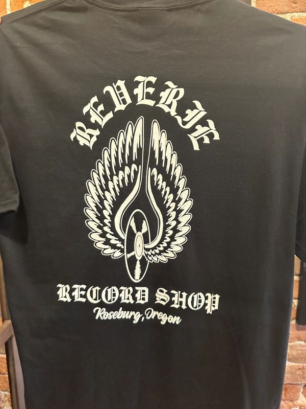 Black T-shirt with Reverie Record Shop logo and wings design.