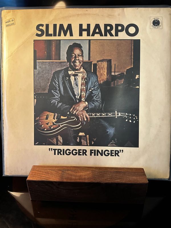 Album cover of Slim Harpo's "Trigger Finger" featuring the artist with his guitar.