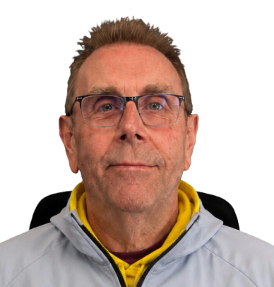 Portrait of a middle-aged man wearing glasses and a gray jacket.