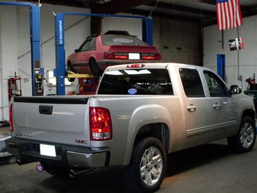 Old silver truck in auto repair garage