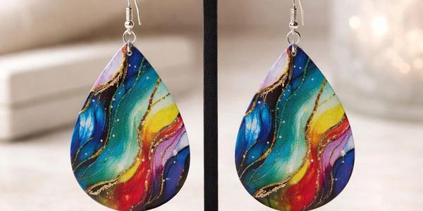 Colorful teardrop earrings with abstract swirling patterns.