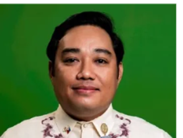 Man wearing traditional Filipino attire with a green background.
